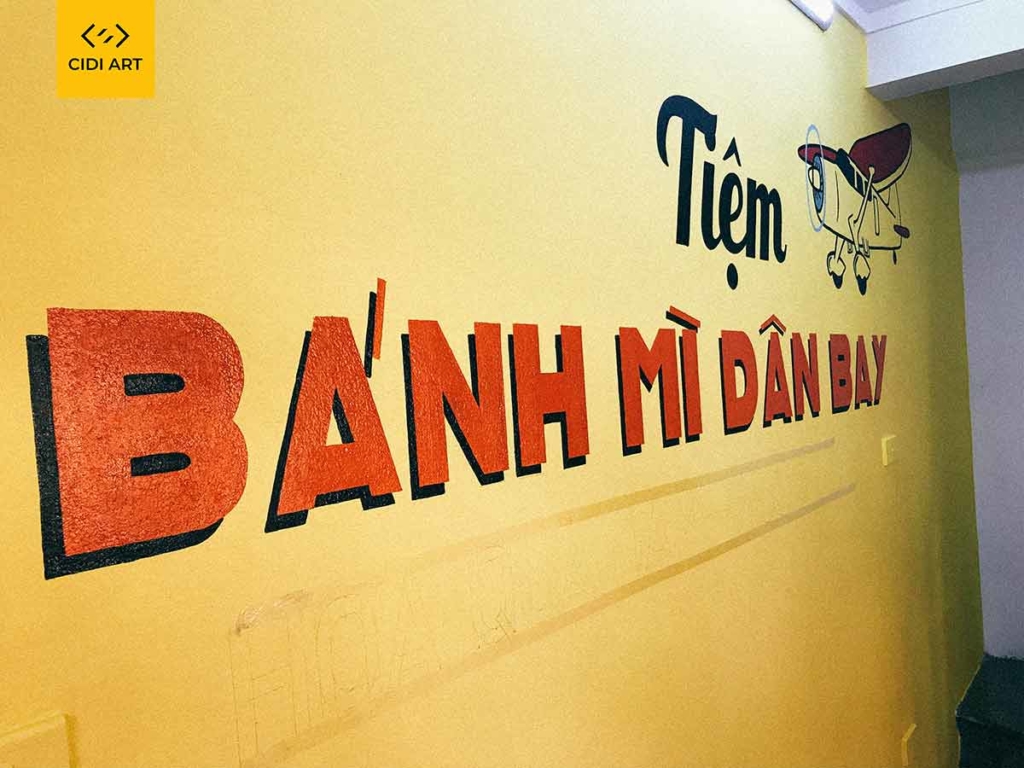 Vẽ tranh tường của hàng bánh mỳ dân bay